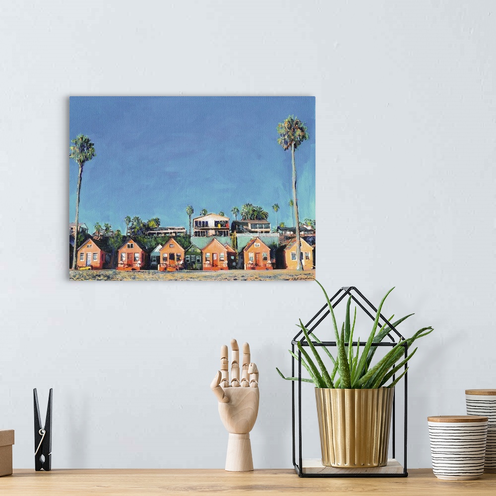 A bohemian room featuring Contemporary painting of a row of beach cottages with palm trees.