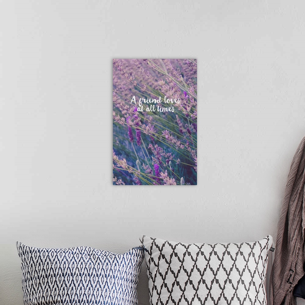 A bohemian room featuring Typography art with a bible verse from Proverbs 17:17 over an image of wildflowers.