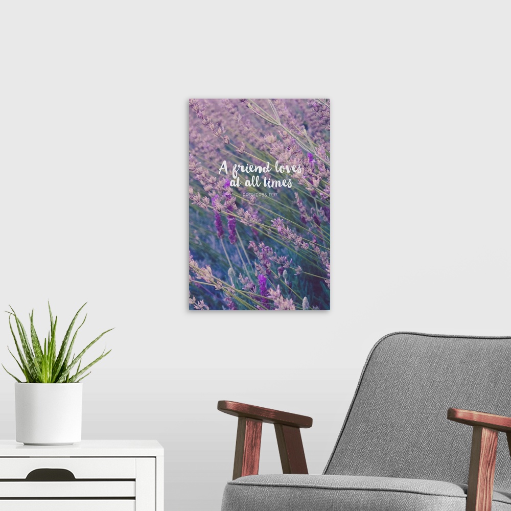 A modern room featuring Typography art with a bible verse from Proverbs 17:17 over an image of wildflowers.