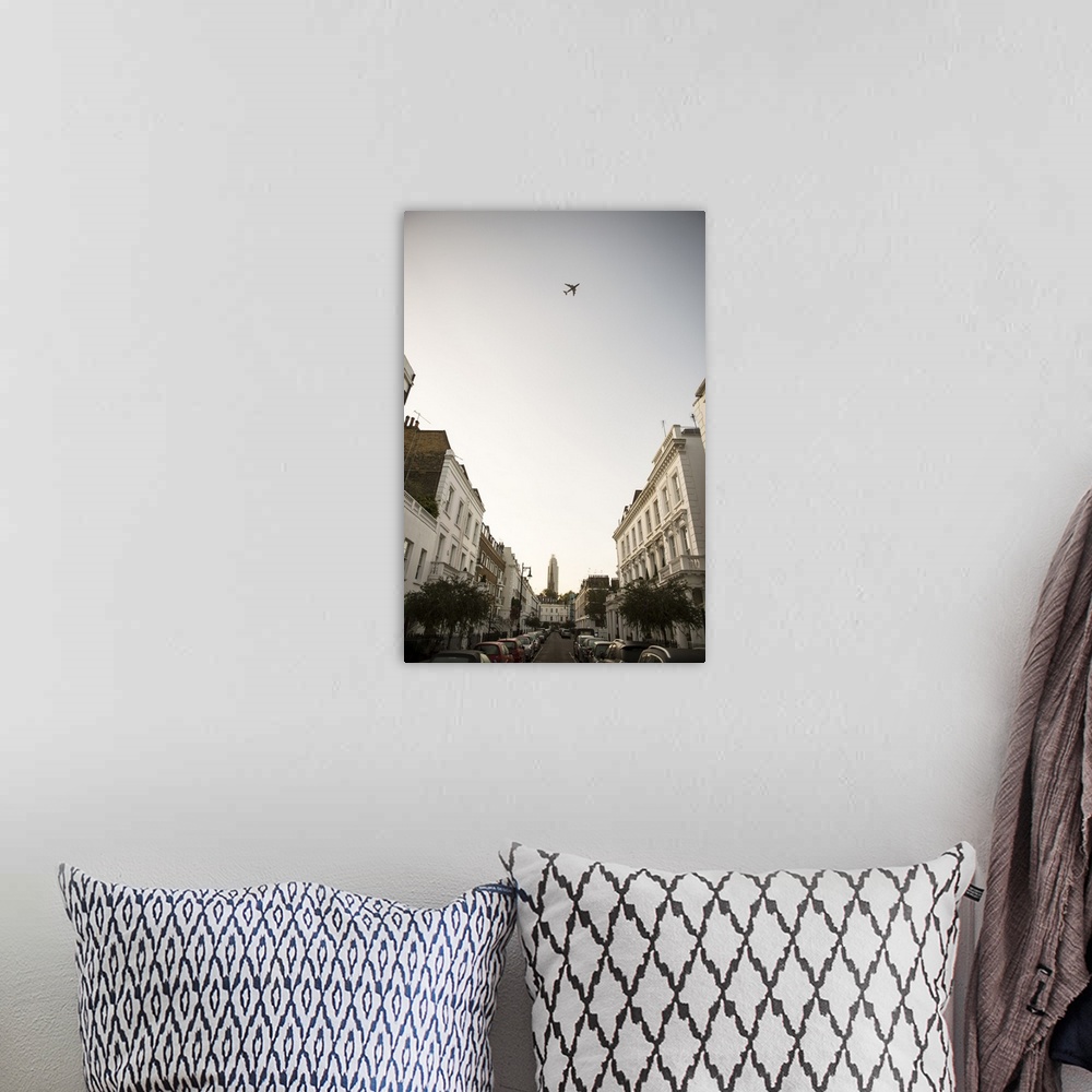 A bohemian room featuring Photograph of an airplane flying over a London cityscape.