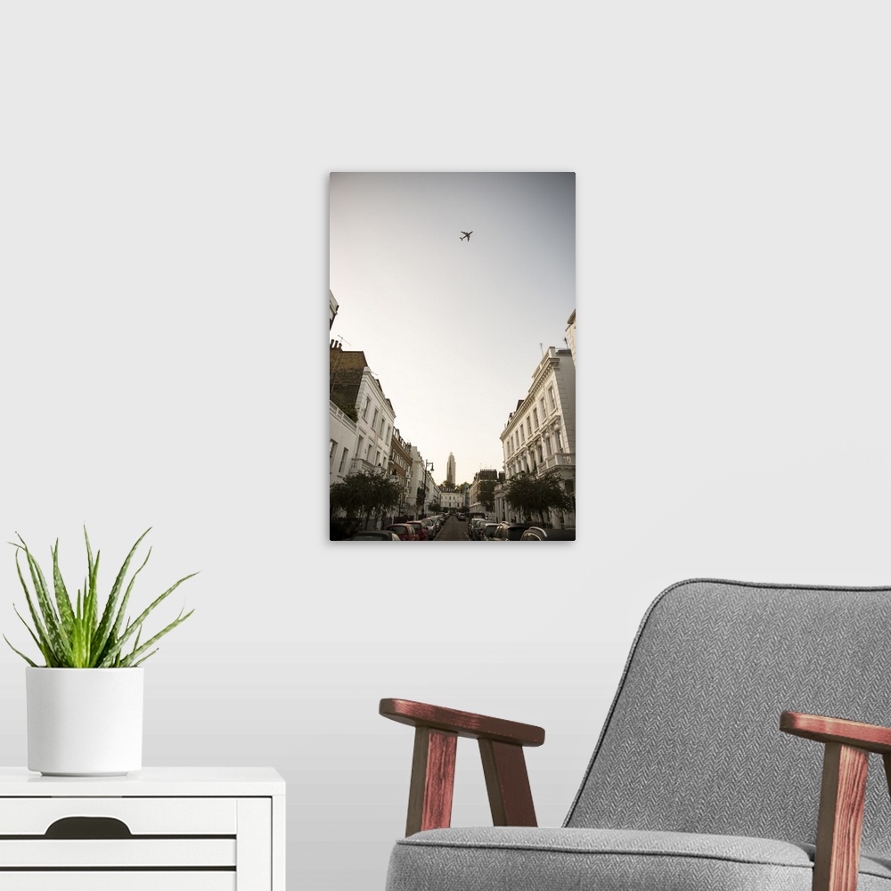A modern room featuring Photograph of an airplane flying over a London cityscape.