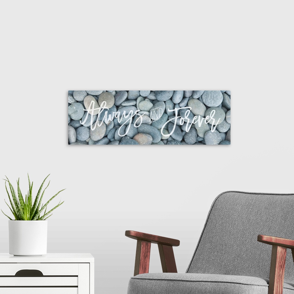 A modern room featuring "Always and Forever" handwritten in flowing script over an image of smooth round pebbles.