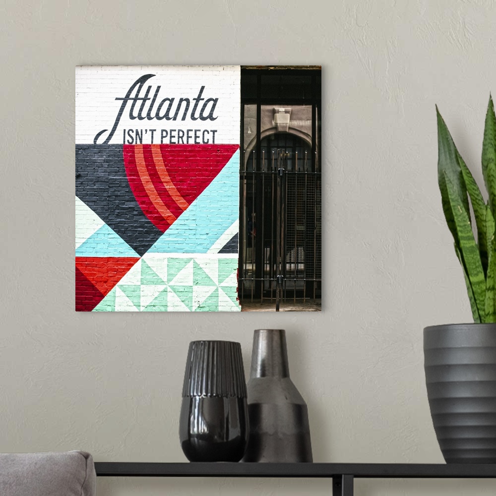 A modern room featuring Atlanta Isn't Perfect, geometric mural featuring a quote by Ryan Gravel, on the side of Switchyar...