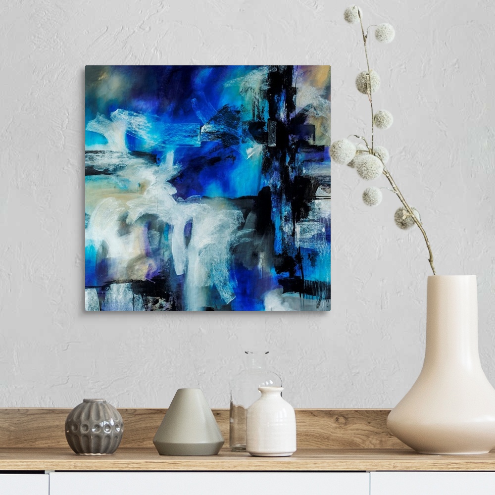 A farmhouse room featuring Abstract artwork painted with bright blue tones underneath thick black and white brushstrokes.