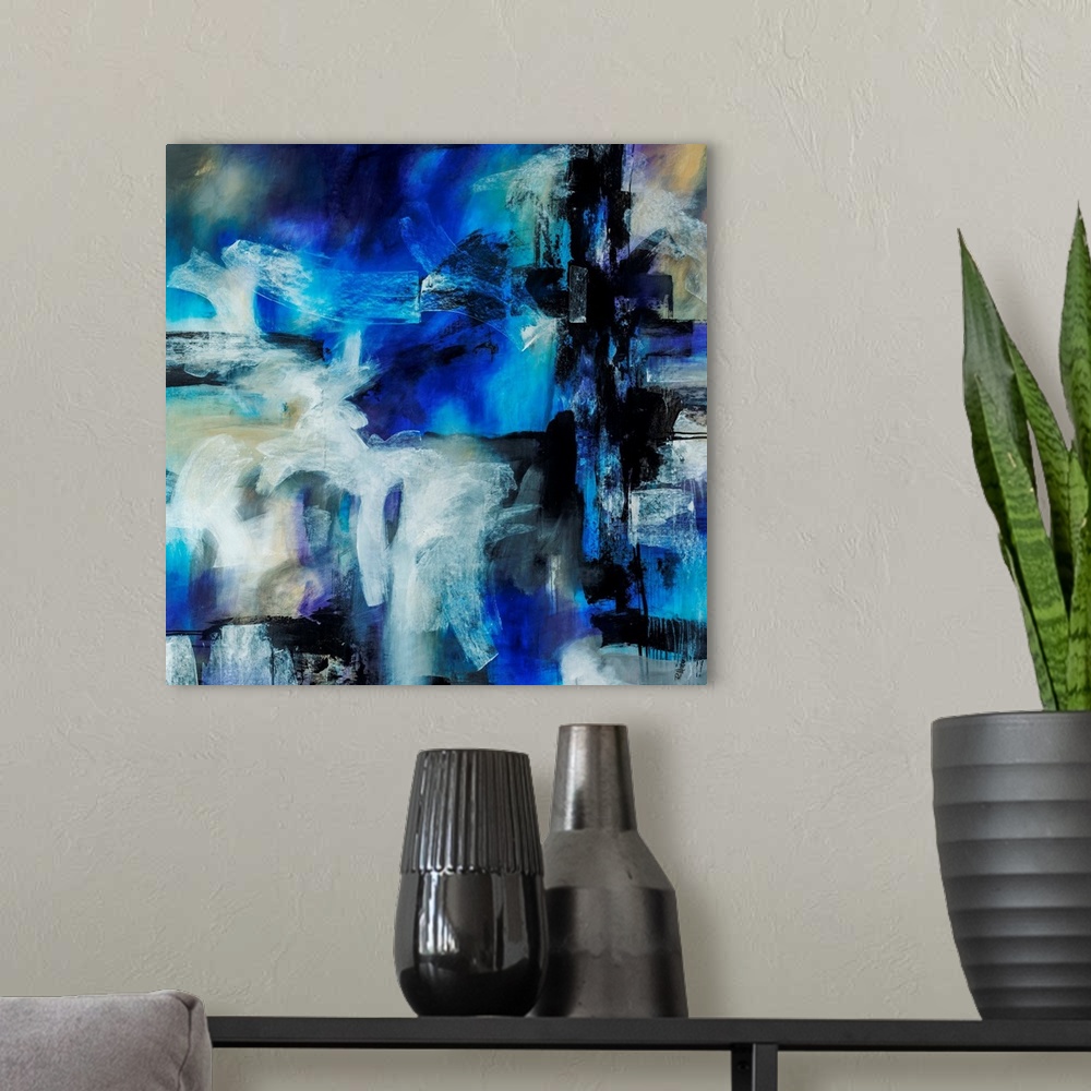 A modern room featuring Abstract artwork painted with bright blue tones underneath thick black and white brushstrokes.
