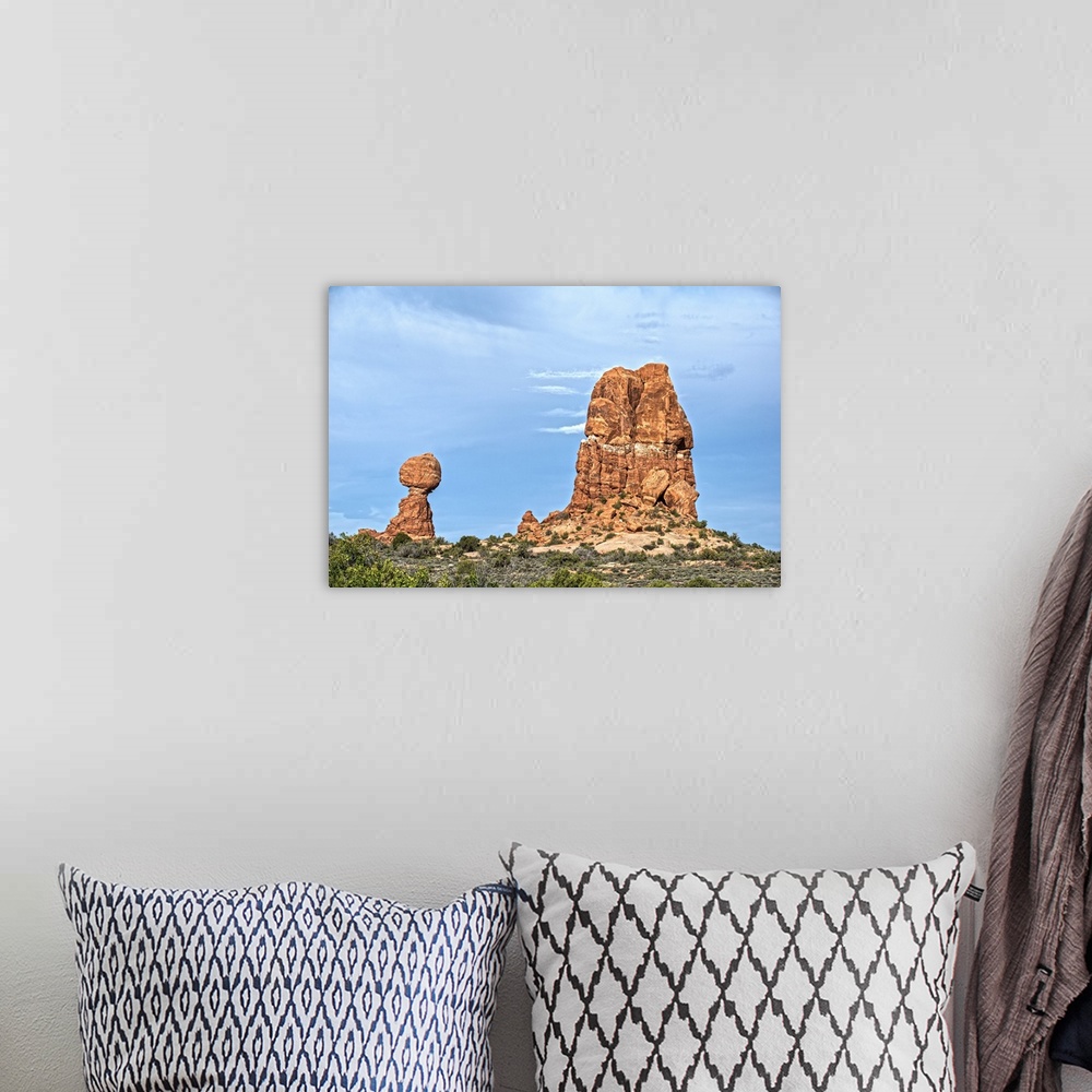 A bohemian room featuring Balanced Rock standing next to a sandstone rock formation under a cloudy sky, Arches National Par...