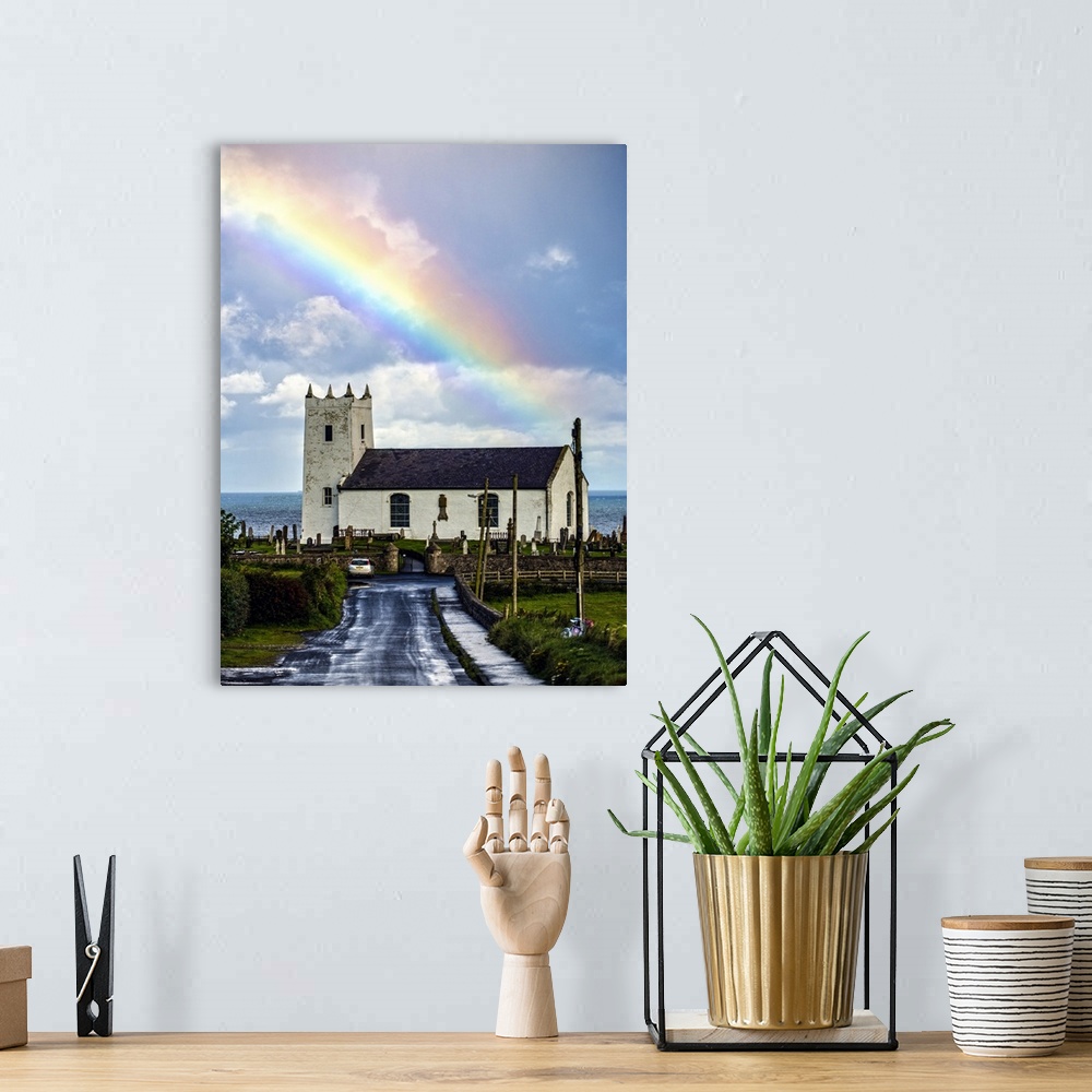 A bohemian room featuring Photograph of Ballintoy Parish Church with a beautiful rainbow behind it over the ocean, at Balli...