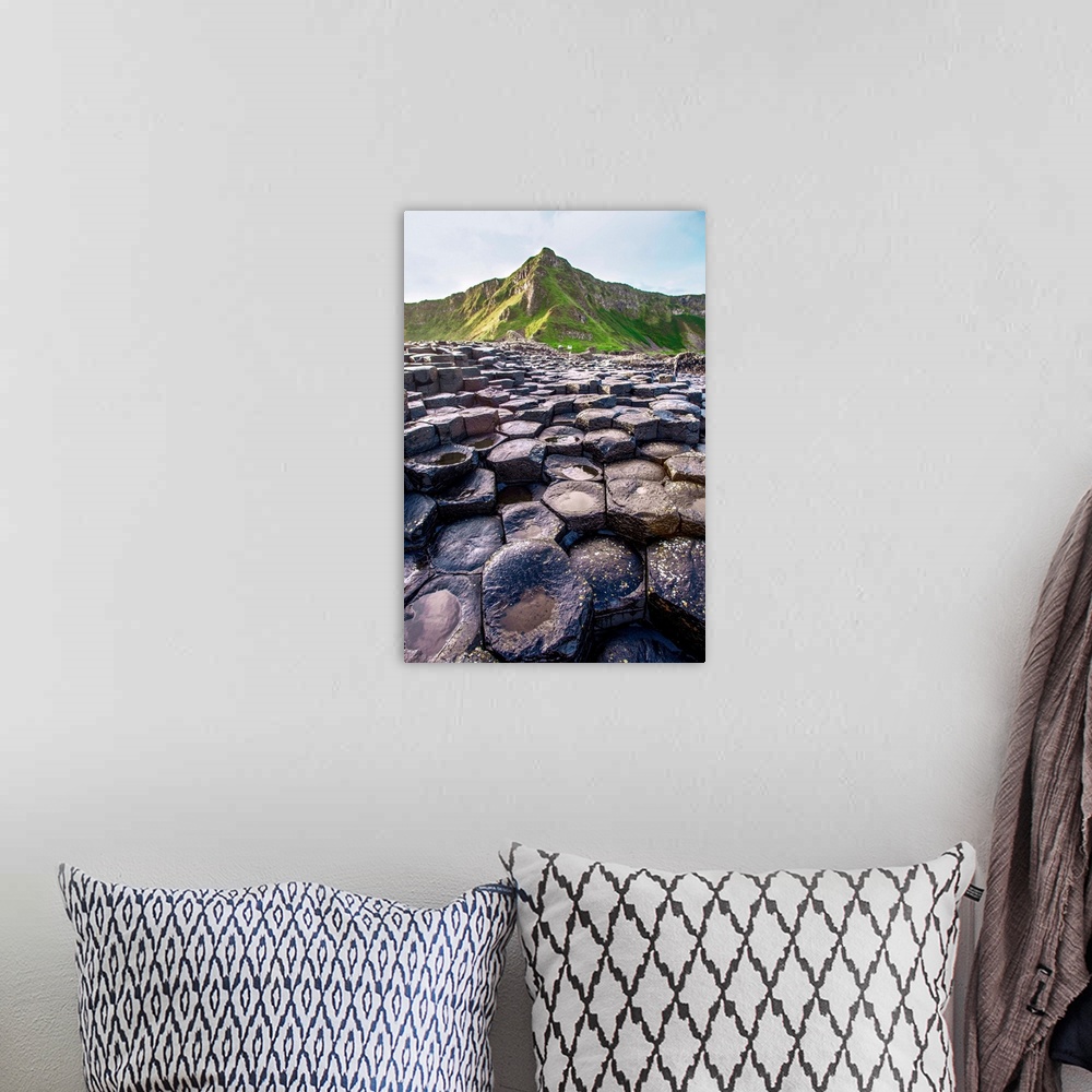 A bohemian room featuring Landscape photograph of the basalt columns on Giant's Causeway with rocky hills and in the backgr...