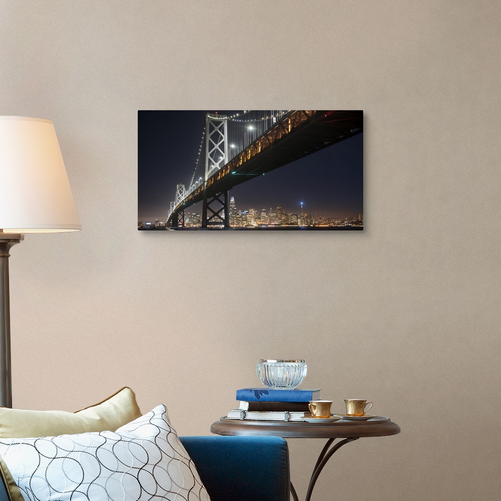 A traditional room featuring Photograph of the Bay Bridge at night from below with the San Francisco skyline lit up in the bac...