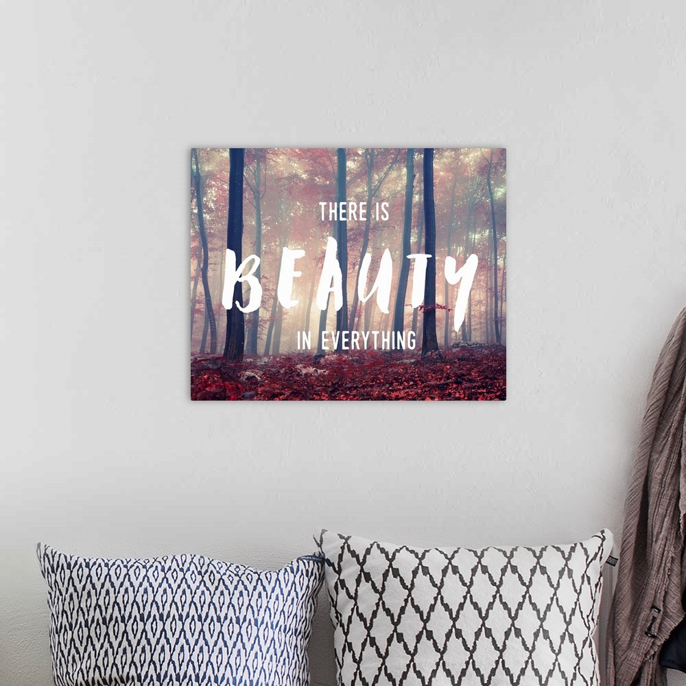 A bohemian room featuring "There is Beauty in Everything" handwritten over an image of a foggy forest glowing with sunlight.