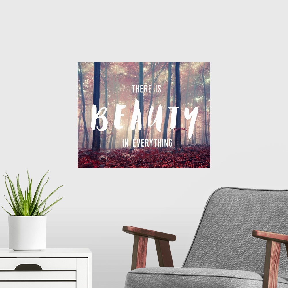 A modern room featuring "There is Beauty in Everything" handwritten over an image of a foggy forest glowing with sunlight.