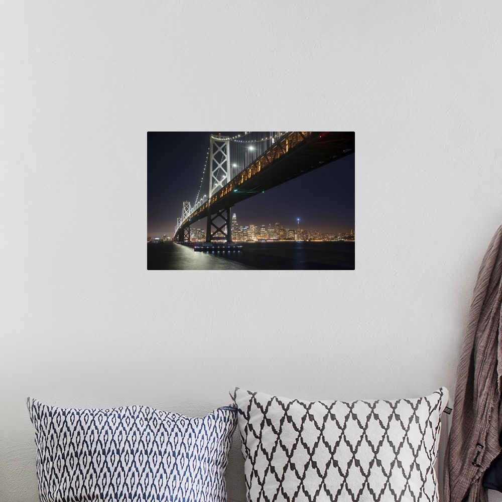 A bohemian room featuring Photograph from below the Bay Bridge at night with the San Francisco skyline lit up in the backgr...