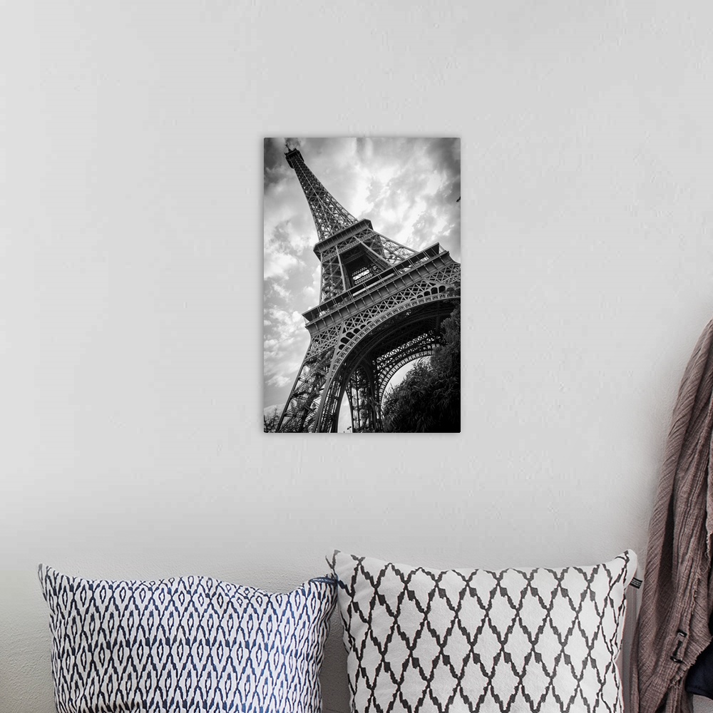 A bohemian room featuring Black and white photograph of he Eiffel Tower from a unique angle.