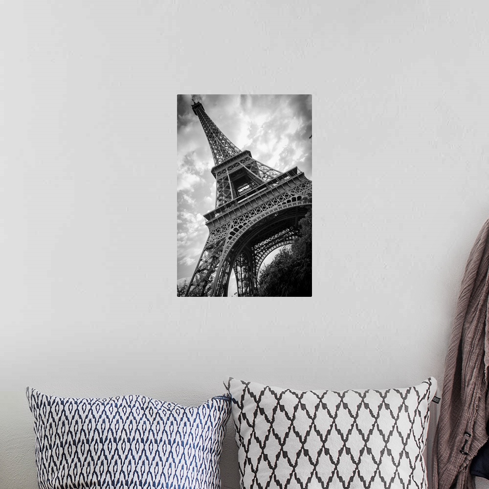 A bohemian room featuring Black and white photograph of he Eiffel Tower from a unique angle.