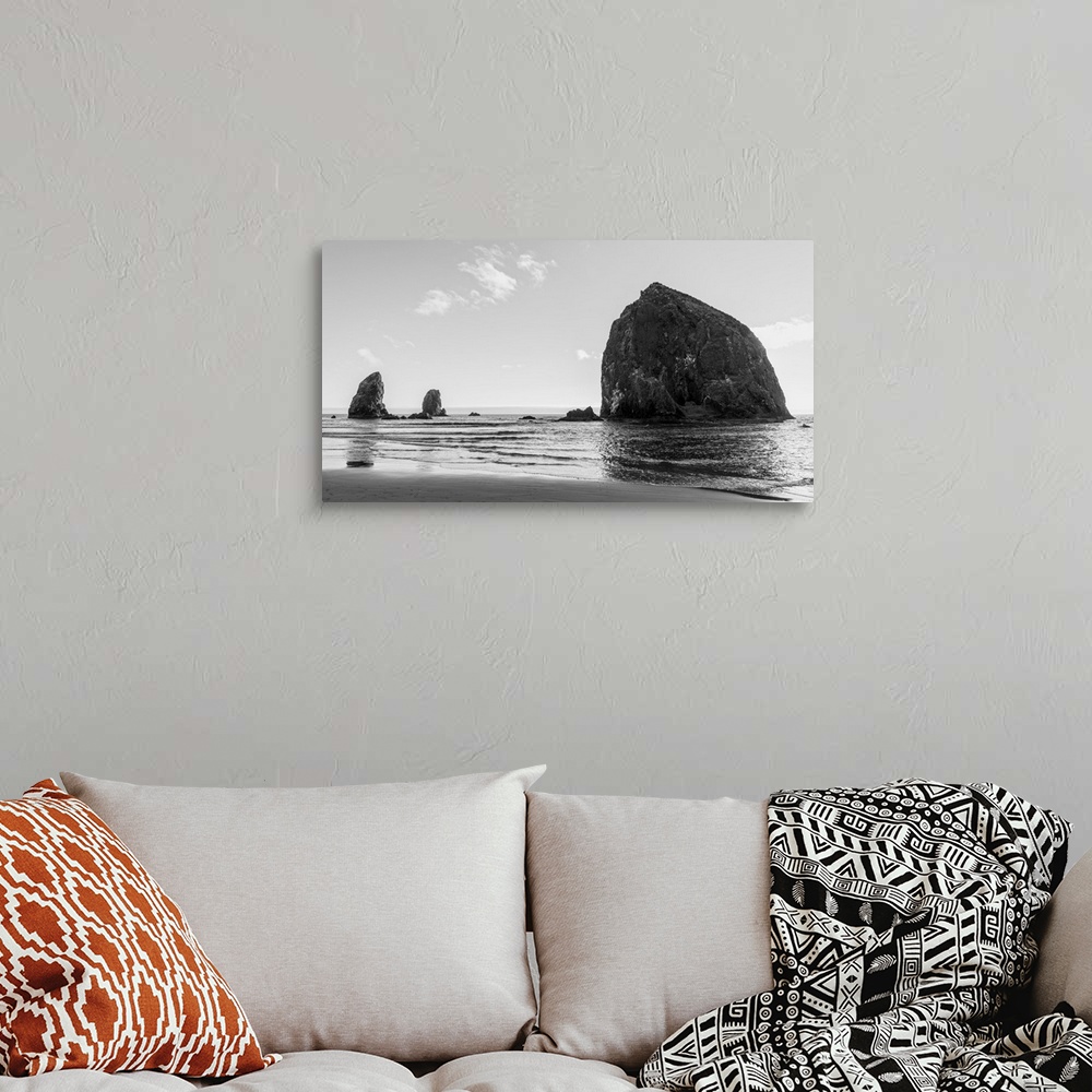 A bohemian room featuring Black and white photograph of Haystack Rock in Oregon.