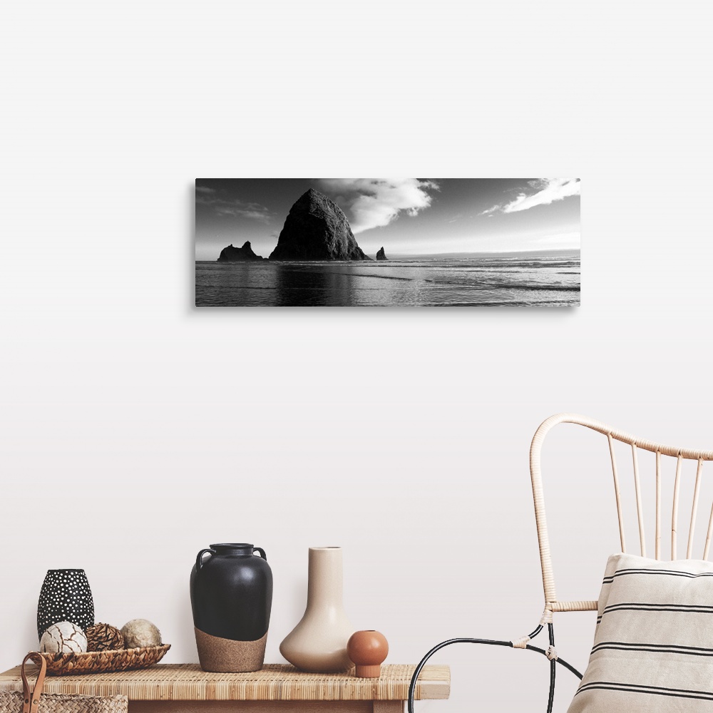 A farmhouse room featuring Black and white panoramic photograph of Haystack Rock with rippling waters.