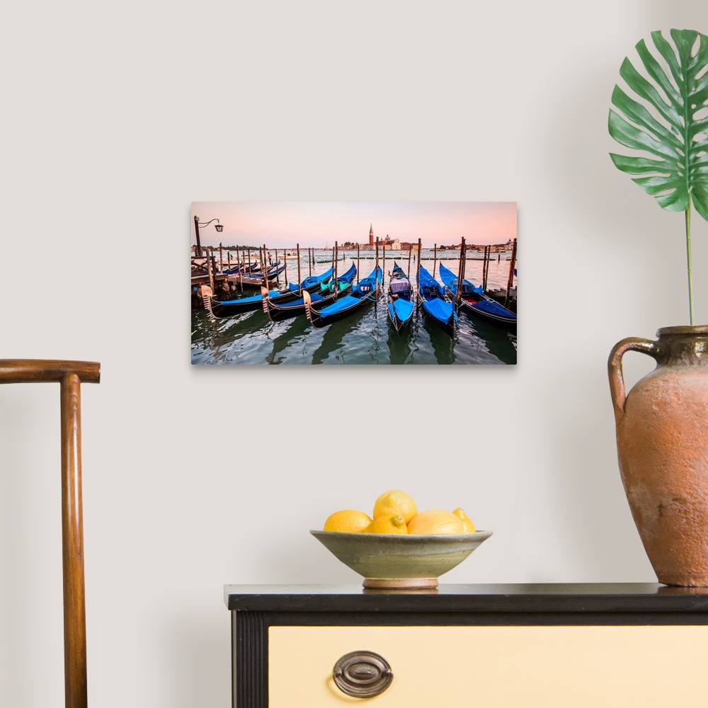 A traditional room featuring Panoramic photograph of blue gondolas docked in a row on the water with St. Mark's Square in the ...