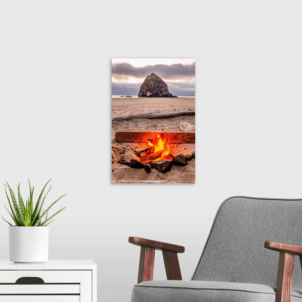 A modern room featuring Photograph of a fire on the beach with Haystack Rock in the background at Cannon Beach, Oregon.