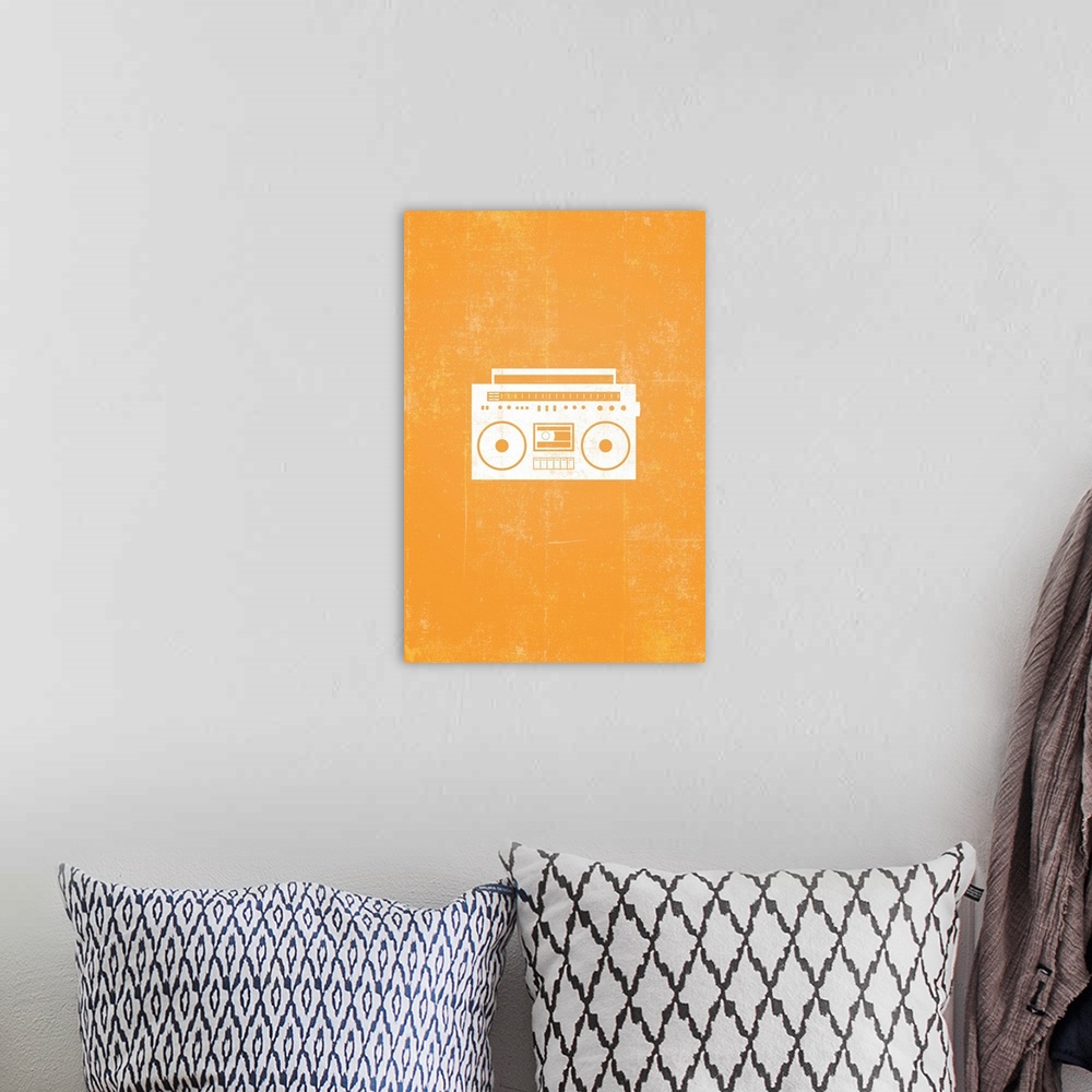 A bohemian room featuring Retro artwork that has a silhouette of a boom box against a bright orange background.