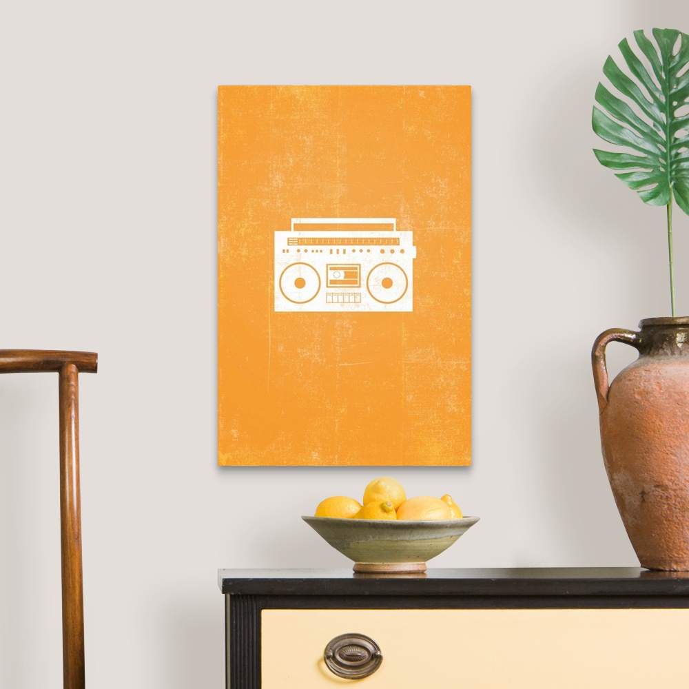 A traditional room featuring Retro artwork that has a silhouette of a boom box against a bright orange background.