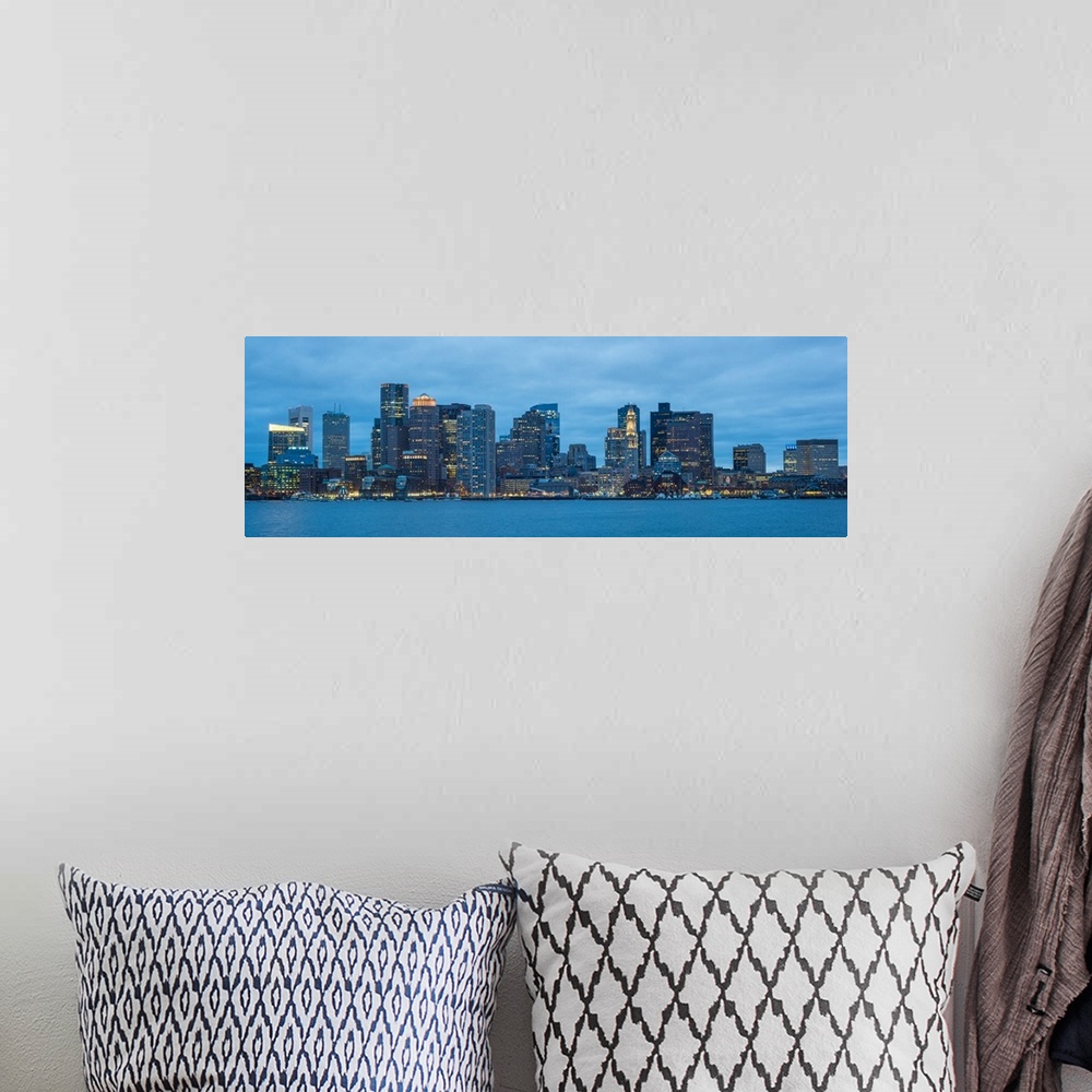 A bohemian room featuring Panoramic view of the Boston City skyline at night, with a cloudy sky overhead.