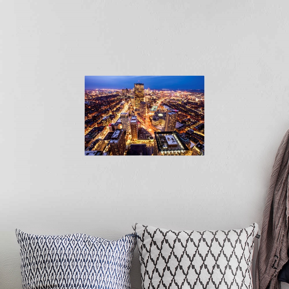 A bohemian room featuring Aerial view of the city of Boston, Massachusetts, lit up at night.