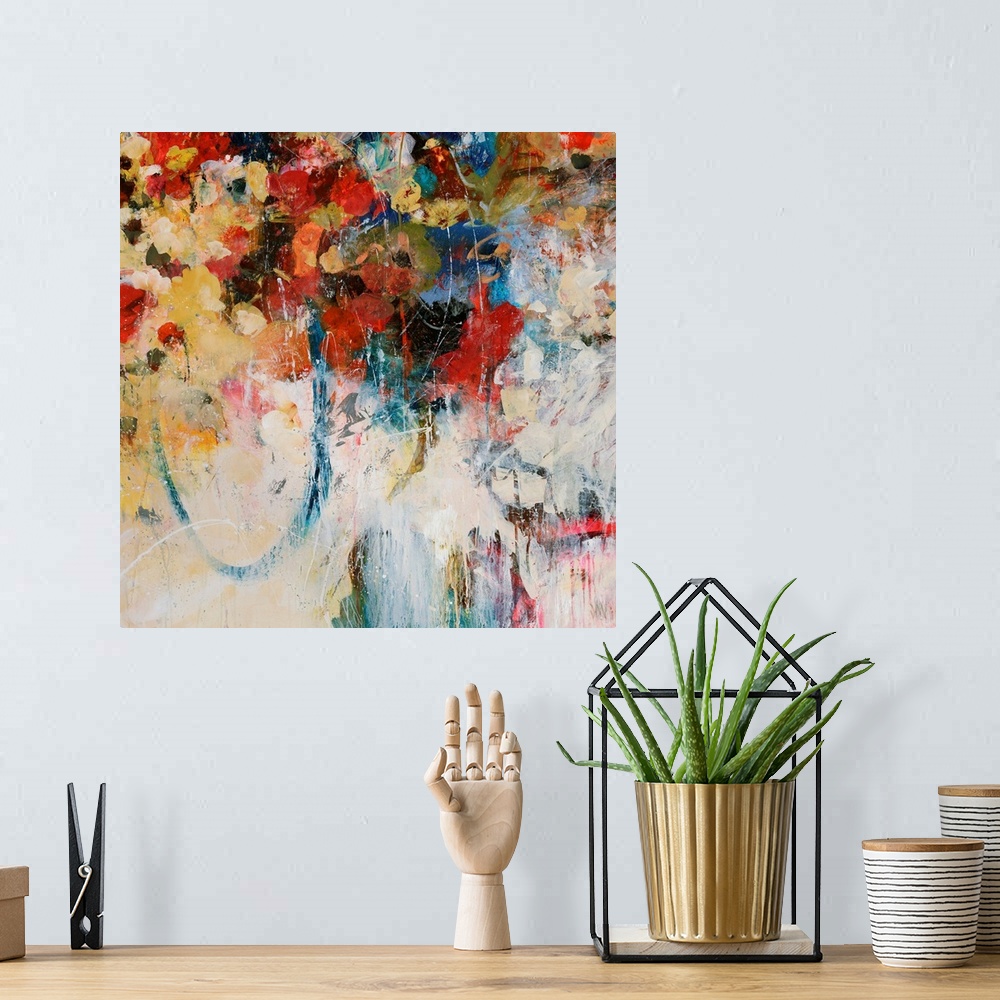 A bohemian room featuring Abstractly painted square canvas with different flowers painted in the top portion and faded colo...
