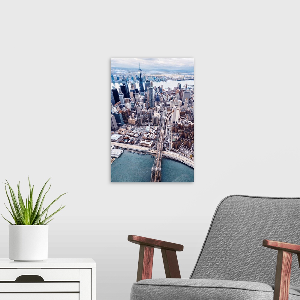 A modern room featuring Aerial view of the Brooklyn Bridge leading into the city, New York City.