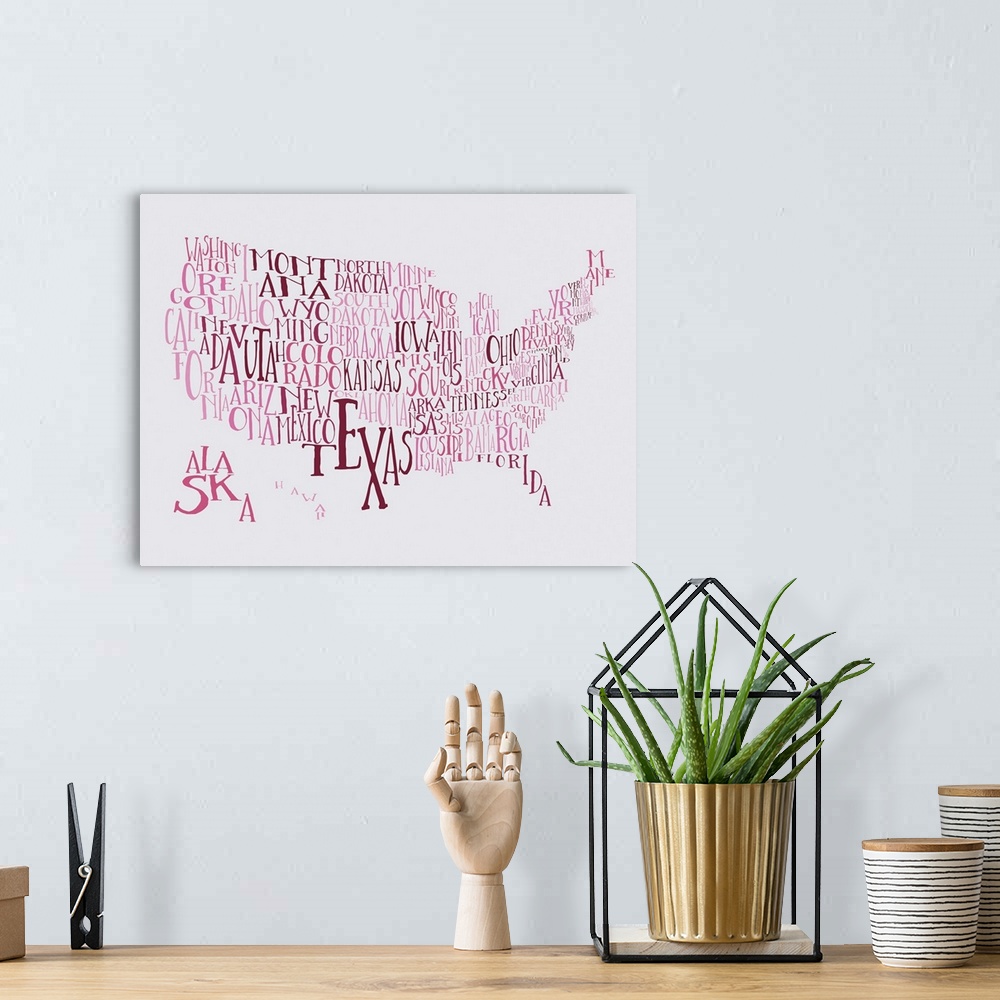 A bohemian room featuring A hand-drawn typography map of the United States with all the state names, in pink and red.