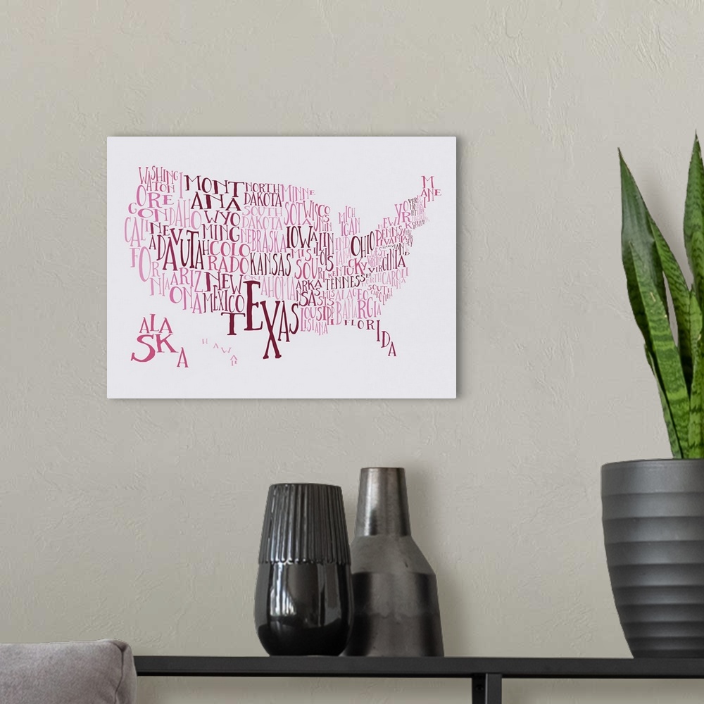 A modern room featuring A hand-drawn typography map of the United States with all the state names, in pink and red.
