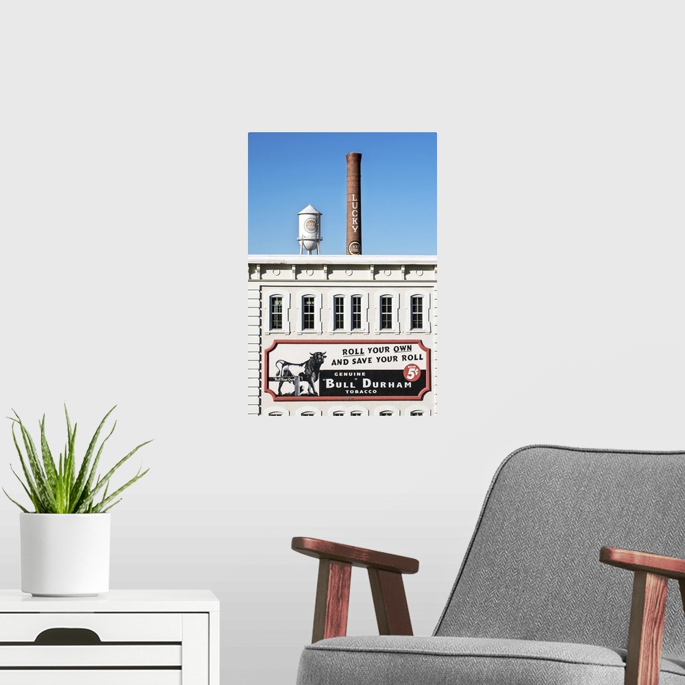 A modern room featuring Bull Durham tobacco advertisement on a building facade, Lucky Strike water tower and smokestack i...