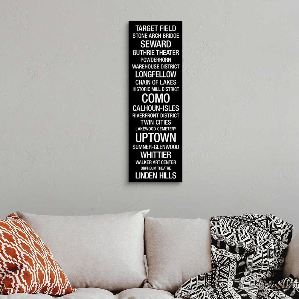 A bohemian room featuring This vertical typographic art work lists city landmarks and neighborhoods in a san serif type fac...