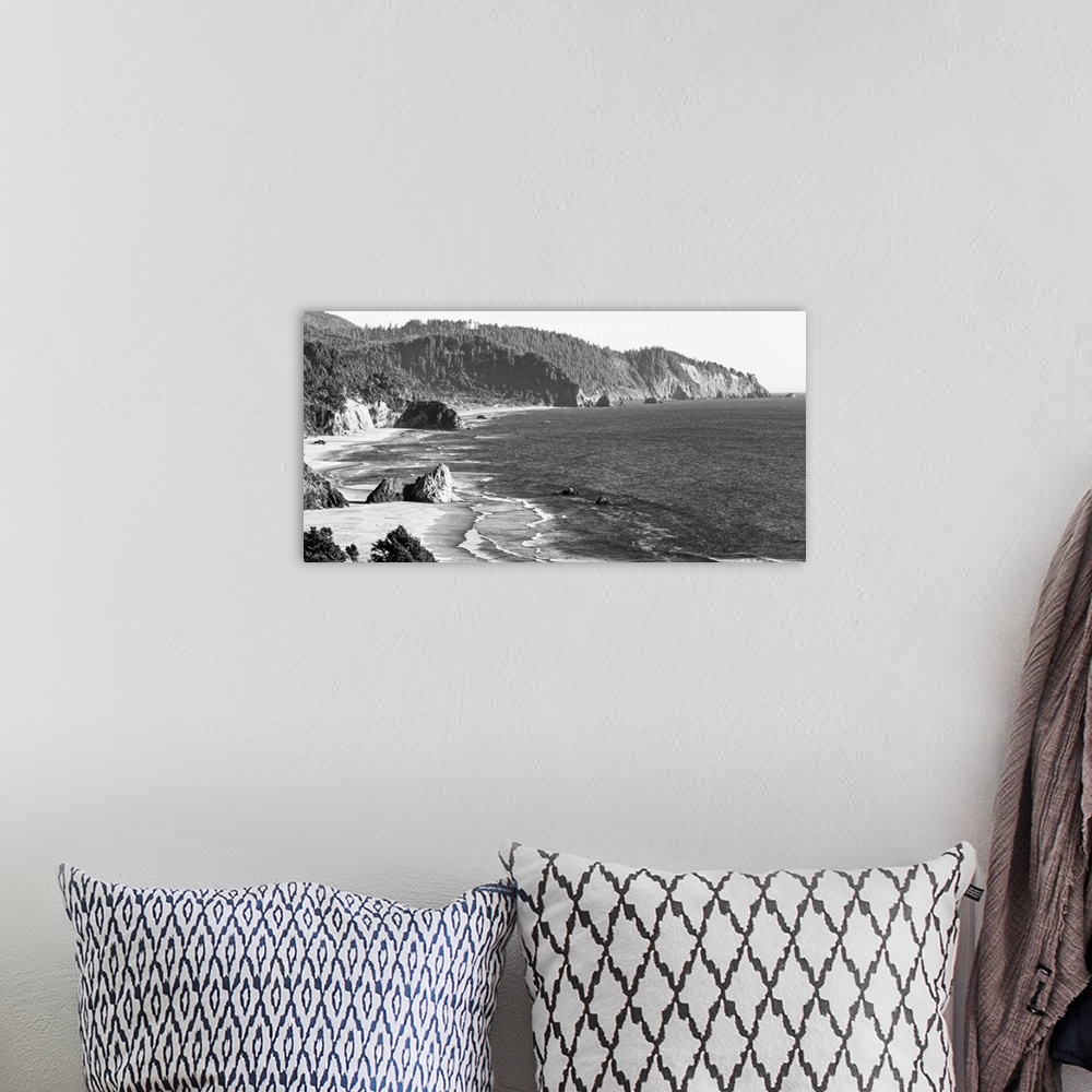 A bohemian room featuring Black and white landscape photograph of the Cannon Beach shore in Oregon.