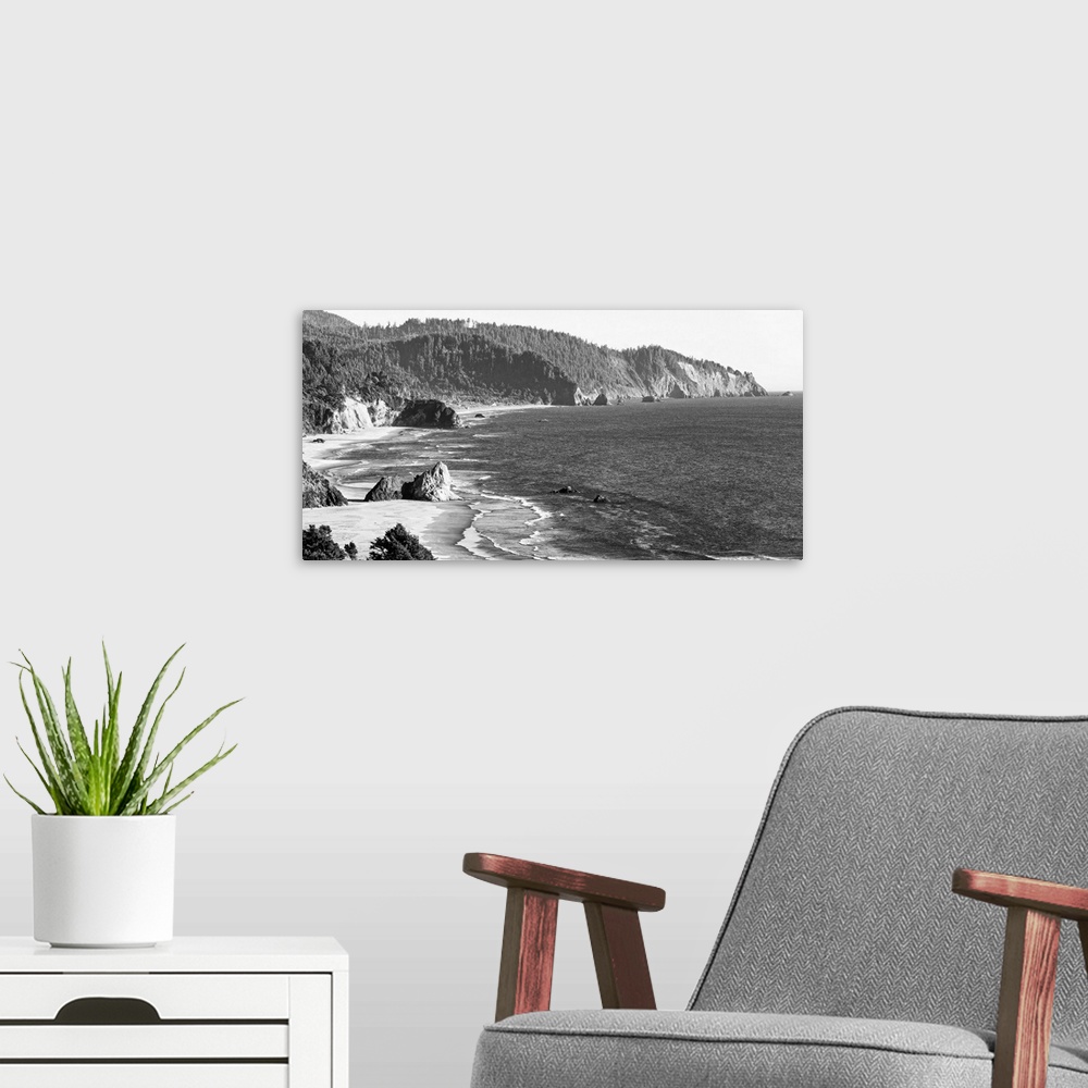 A modern room featuring Black and white landscape photograph of the Cannon Beach shore in Oregon.