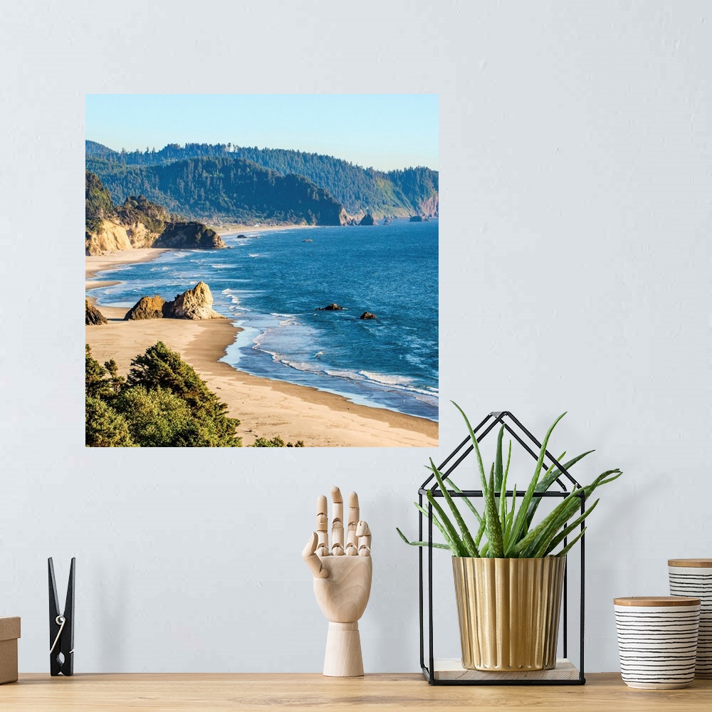 A bohemian room featuring Square photograph of the blue pacific waters on the Oregon coast at Cannon Beach.