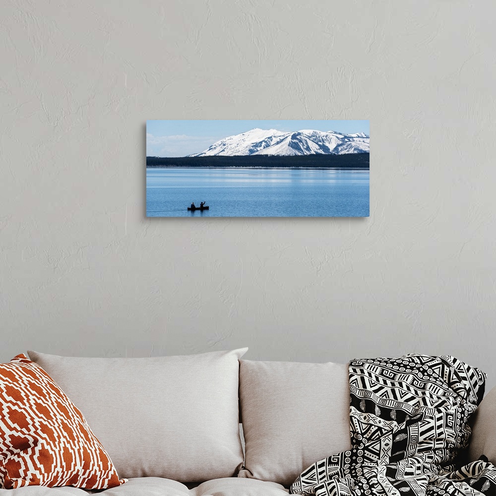 A bohemian room featuring Two people canoeing on Jackson Lake with the snow covered Grand Teton mountains in the background.