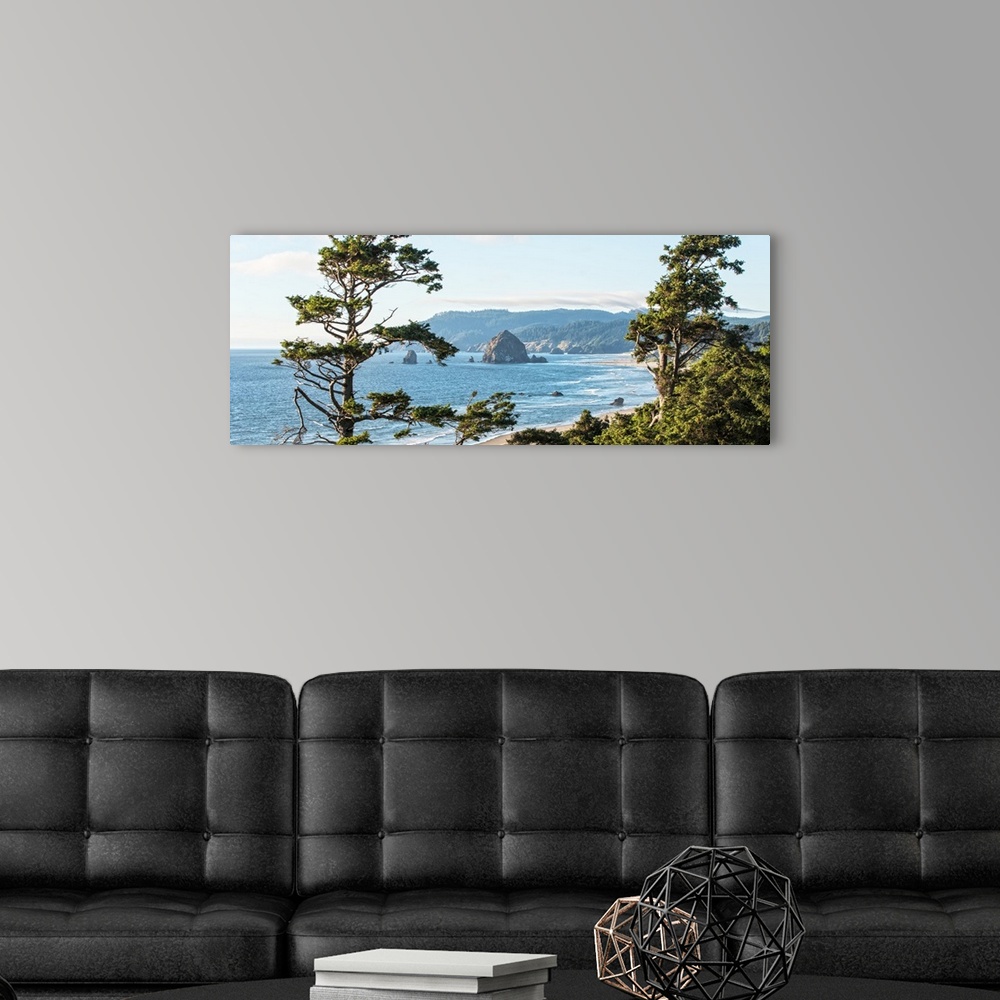 A modern room featuring Landscape photograph of Cannon Beach through the trees with Haystack Rock in the distance, Oregon...