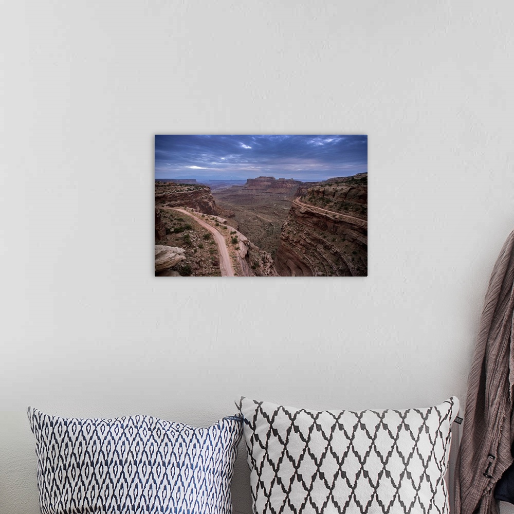 A bohemian room featuring Landscape photograph of a view at Canyonlands National Park with a dark blue sky.