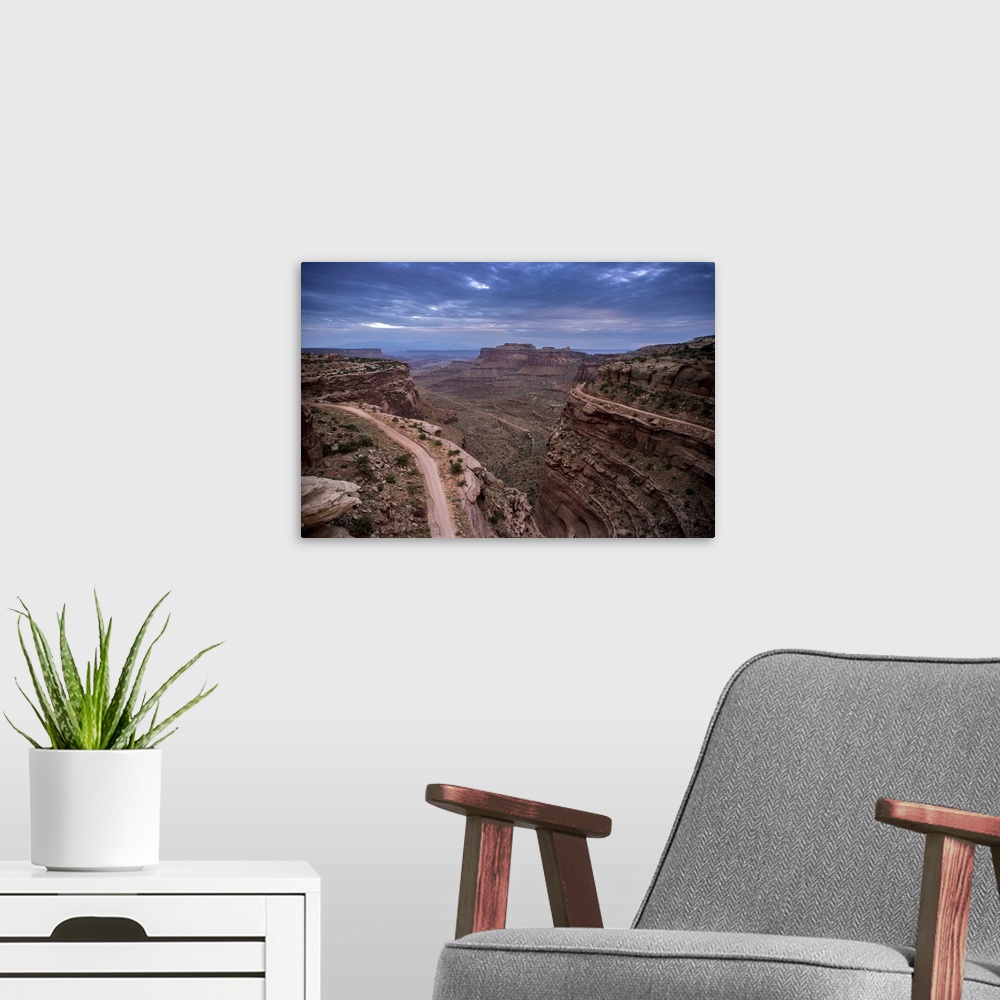 A modern room featuring Landscape photograph of a view at Canyonlands National Park with a dark blue sky.