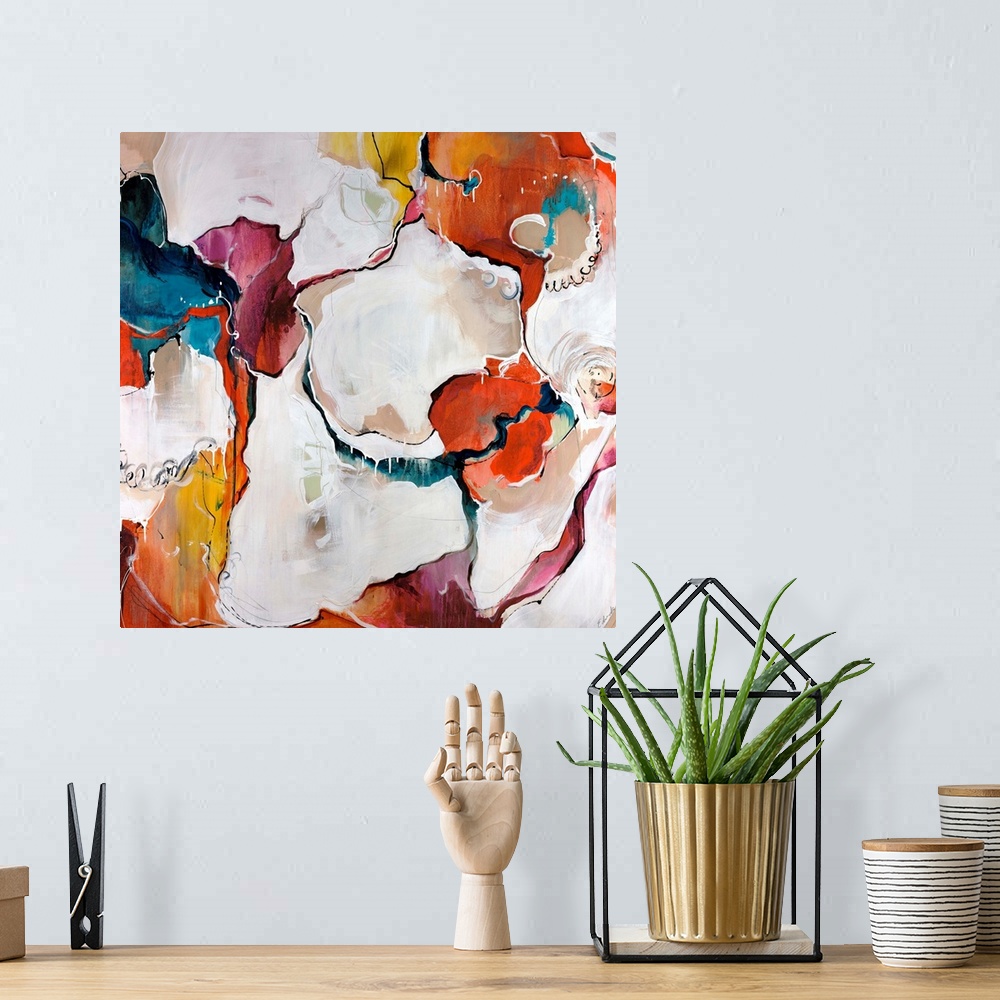 A bohemian room featuring A colorful piece of square artwork that is abstract with creamy paint textures.
