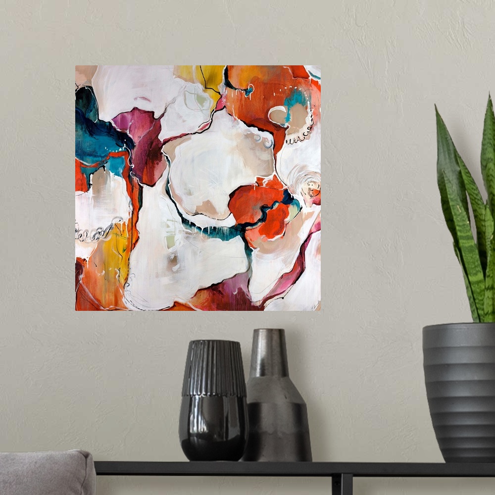 A modern room featuring A colorful piece of square artwork that is abstract with creamy paint textures.