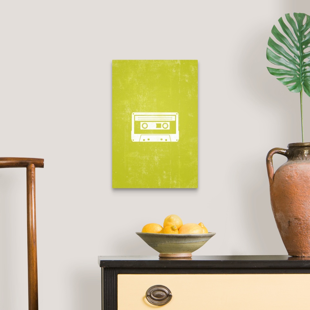 A traditional room featuring Retro artwork that has a silhouette of a cassette tape against a neon green background.