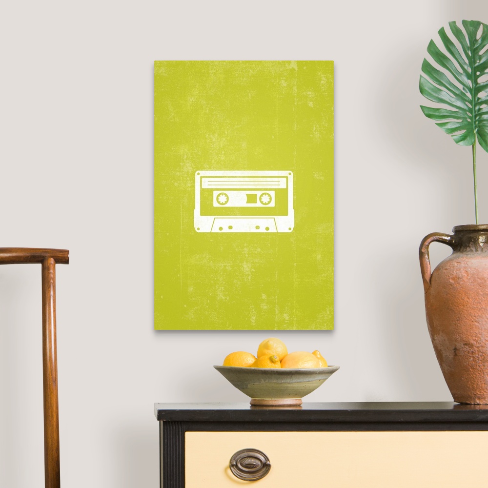 A traditional room featuring Retro artwork that has a silhouette of a cassette tape against a neon green background.