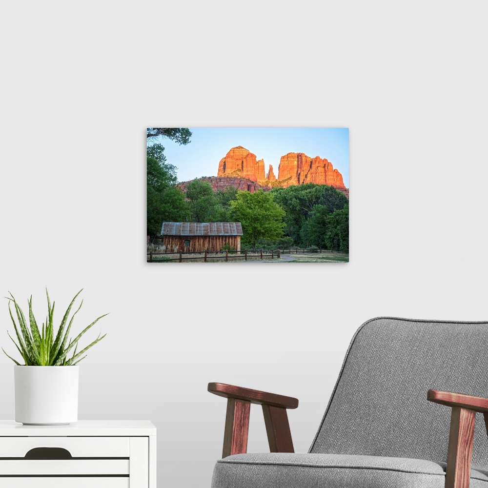 A modern room featuring Landscape photograph of Cathedral Rock with a rustic wooden structure in the foreground.