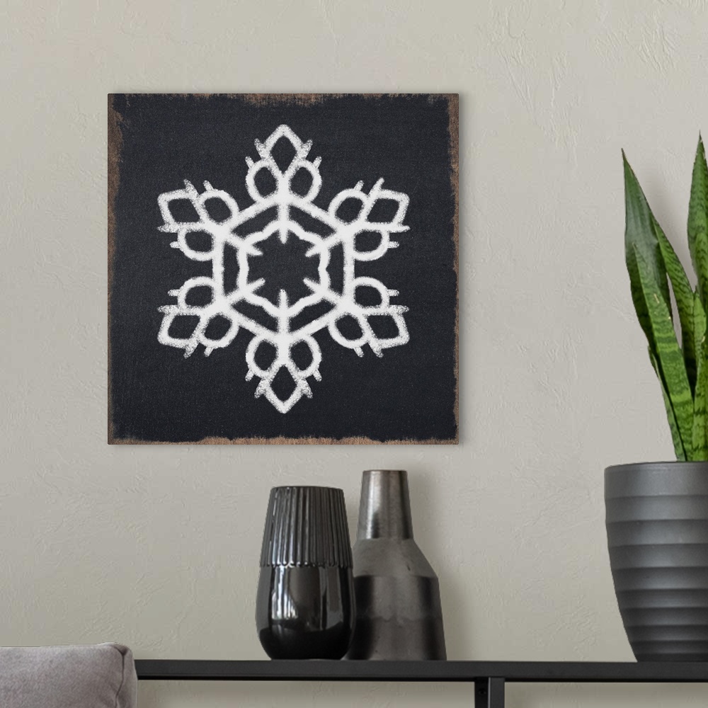 A modern room featuring Square illustration of a white snowflake on a black chalkboard background.