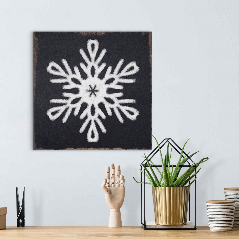 A bohemian room featuring Square illustration of a white snowflake on a black chalkboard background.