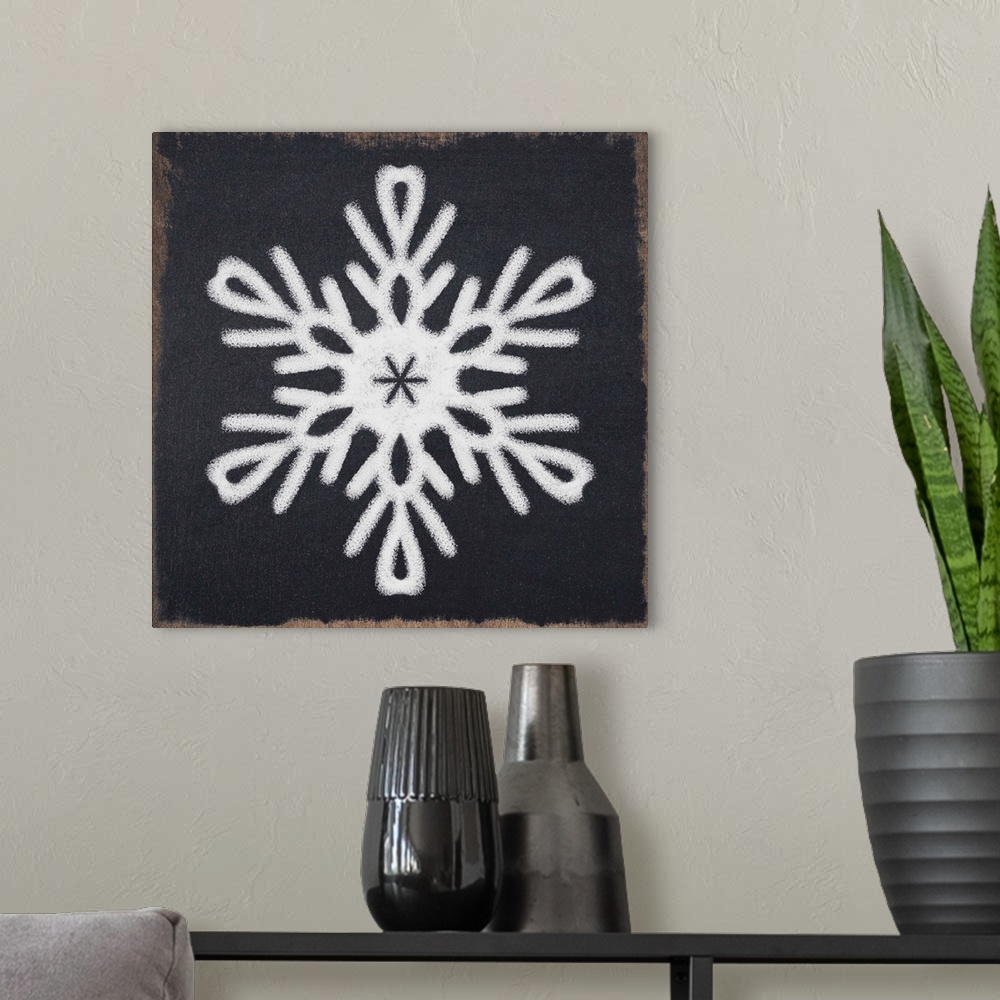A modern room featuring Square illustration of a white snowflake on a black chalkboard background.