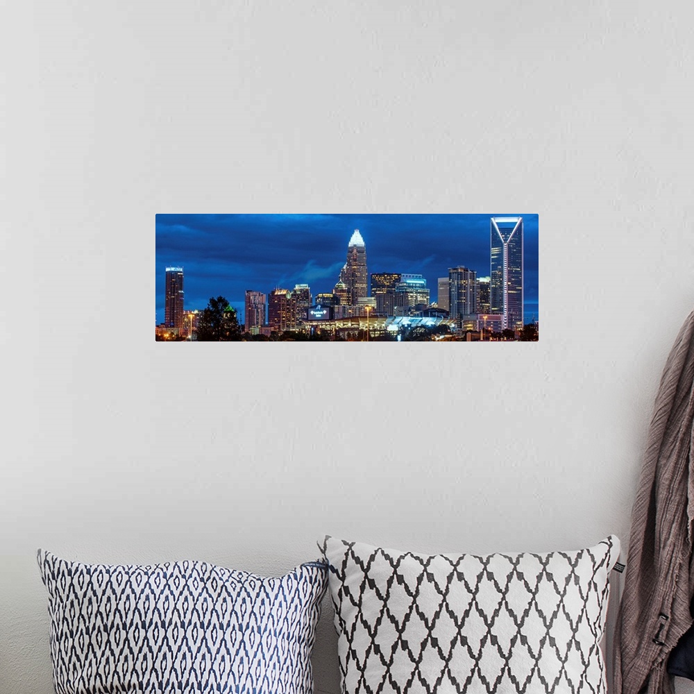 A bohemian room featuring Horizontal image of the city of Charlotte, North Carolina at night.