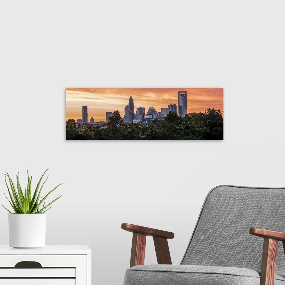A modern room featuring The sun setting on the largest city in North Carolina.