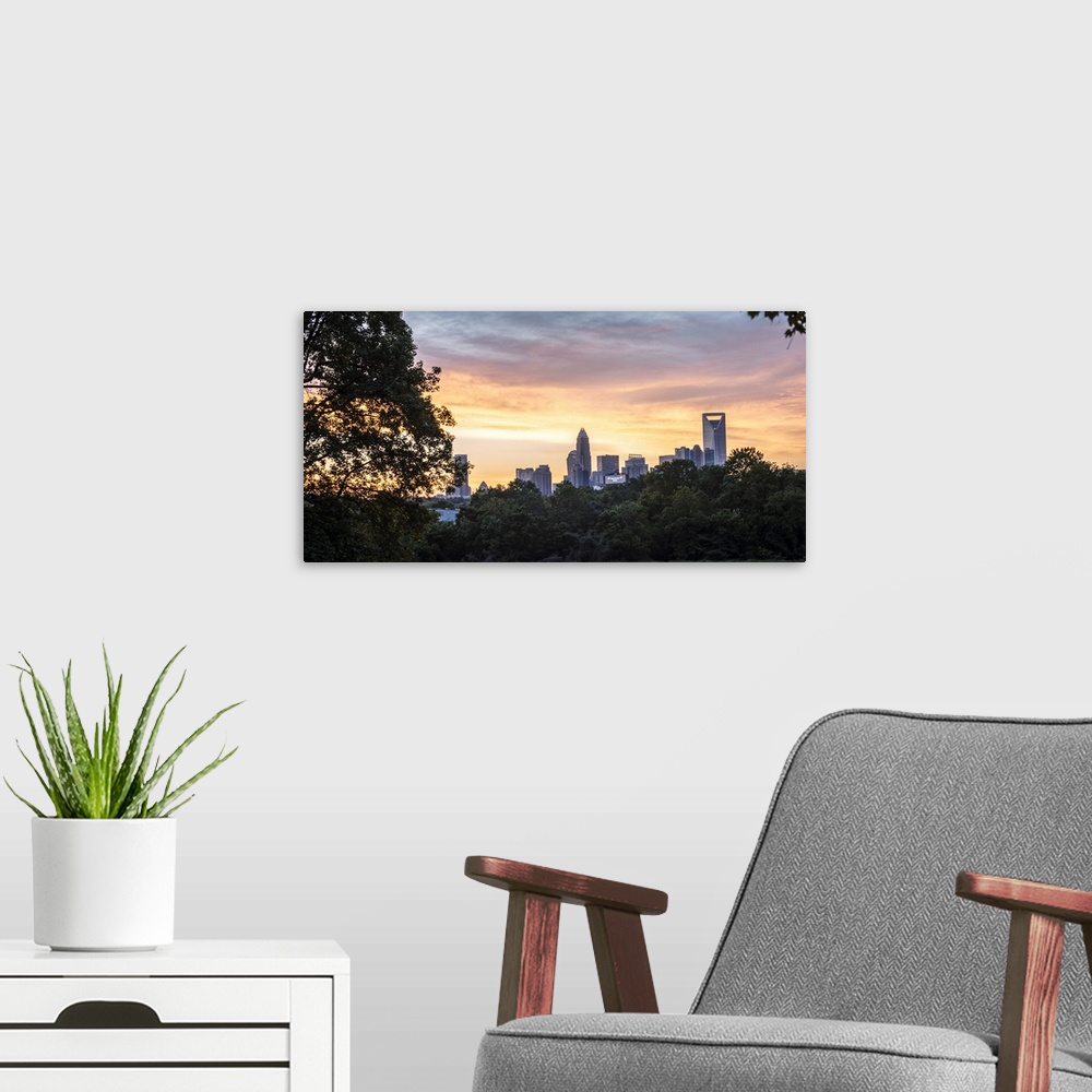 A modern room featuring The sun setting on the largest city in North Carolina.